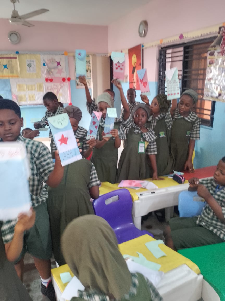 ACES pupils holding up the craft cards they have made