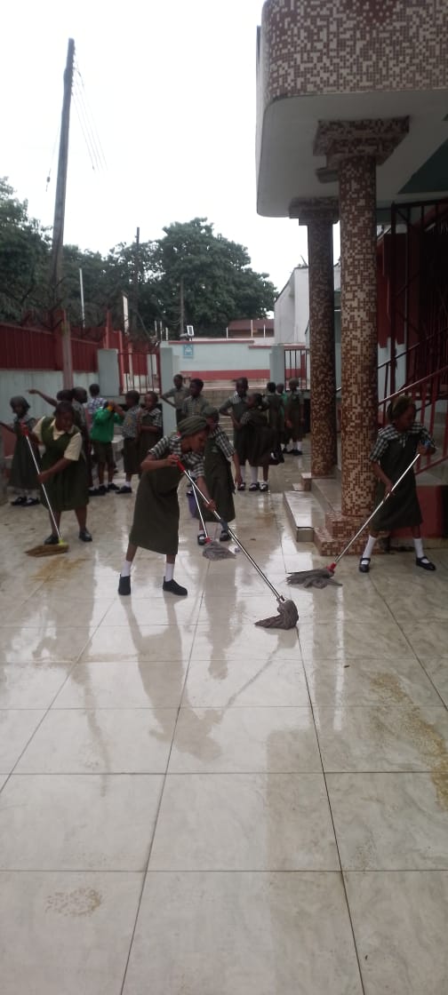 ACES pupils cleaning the school terrace on Sanitation Day